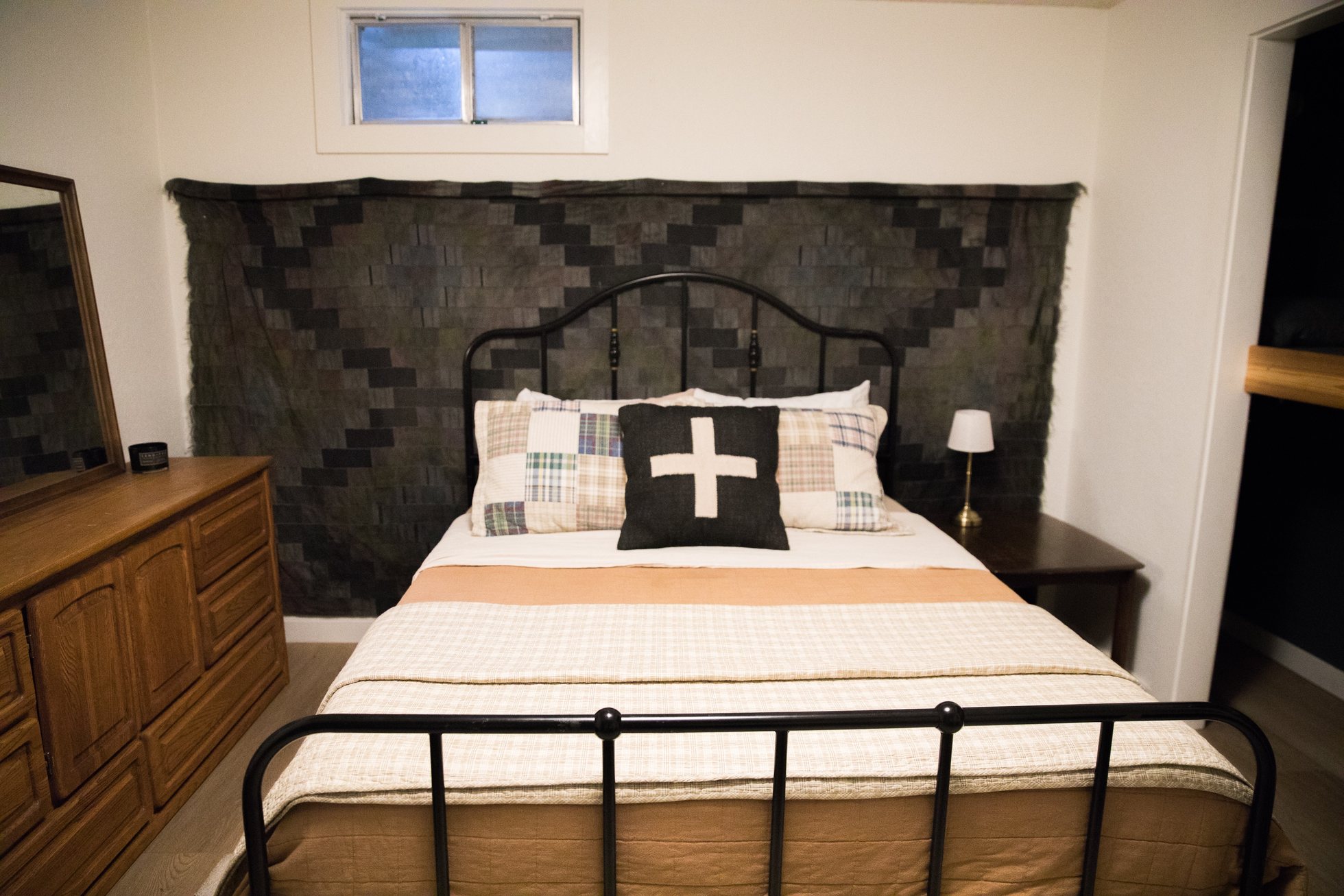 Bedroom with patterned headboard and natural light