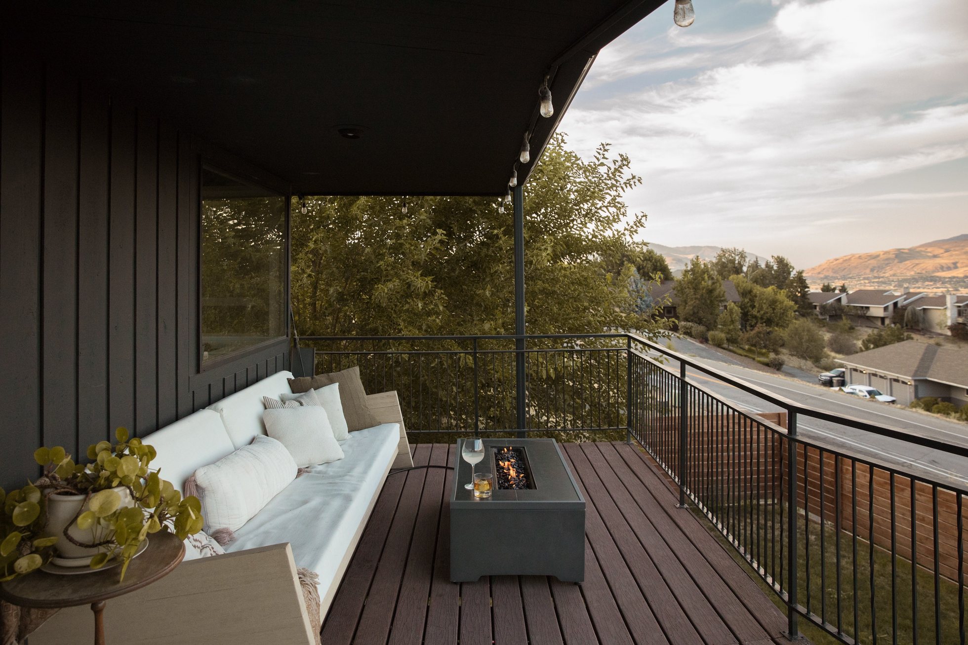 Outdoor deck with seating and a fire table overlooking the Wenatchee Valley