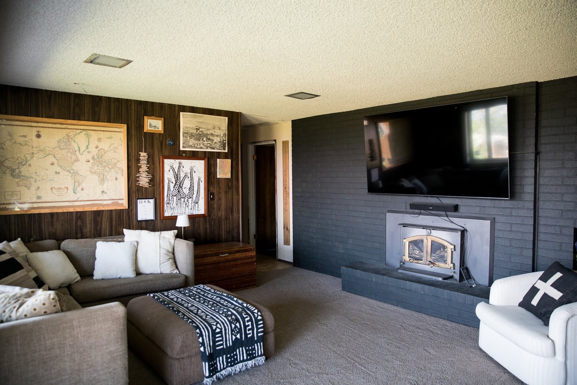 Cozy media room with couch and wood-paneled walls